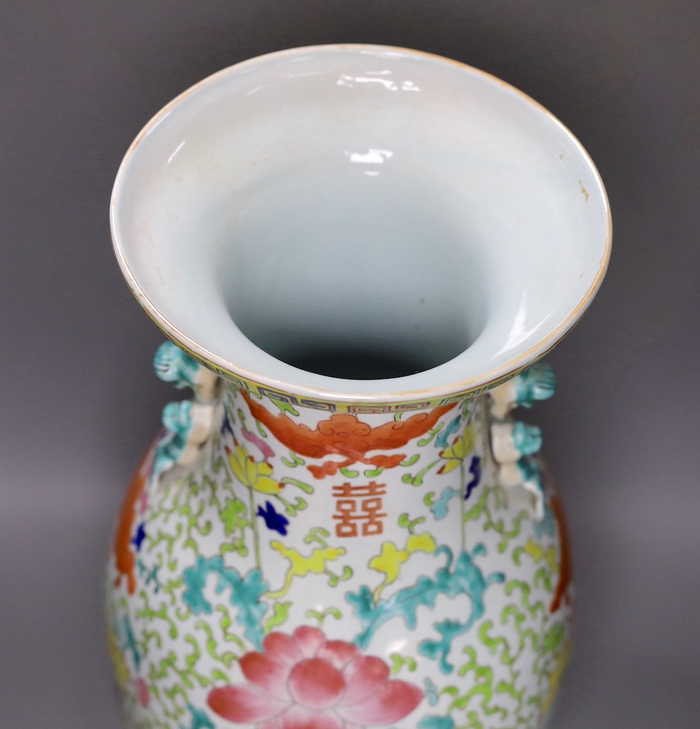 A large Chinese enamelled porcelain vase, on wood stand 53cm